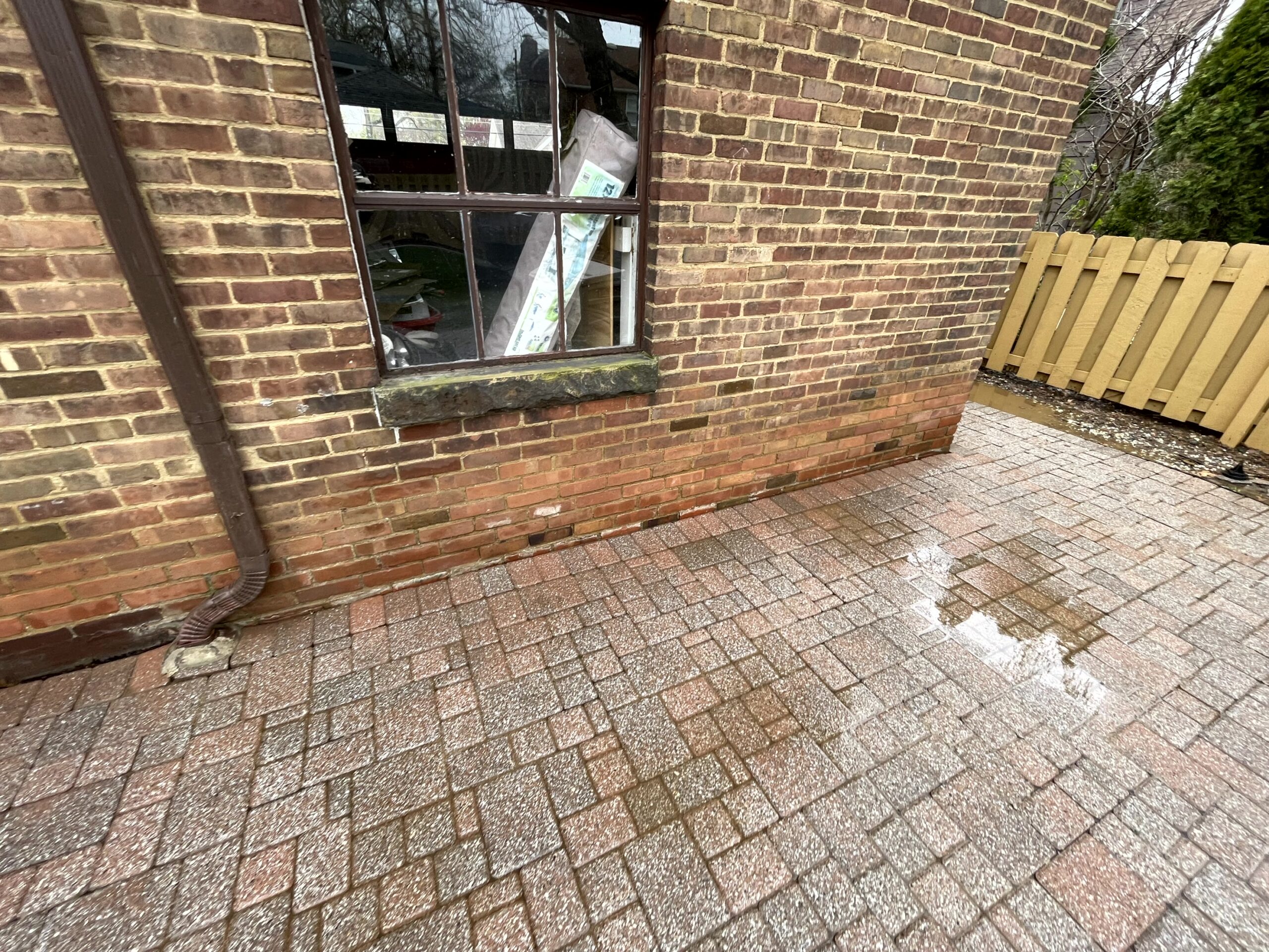 dirty brick house after pressure washing